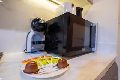 a counter top with a microwave and a plate of food at EasyGo- City Center, Spacious, Skyline view in Dubai
