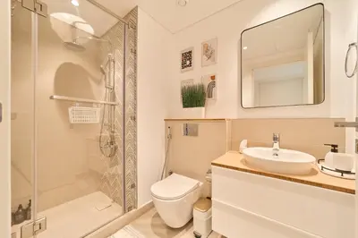 a bathroom with a toilet and a sink and a shower at Chic & Modern 1BR in Socio Near Dubai Hills Park in Dubai