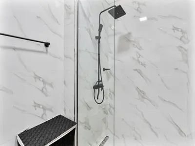 a shower with a glass door in a bathroom at Savis Homes - Luxury Brand New Studio in Elysee III in JVC in Dubai