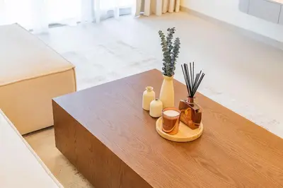 a wooden coffee table with vases and flowers on it at New 1BR Burj view- Infinity Pool - Dubai Mall in Dubai