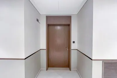 a hallway with a wooden door in a building at New 1BR Burj view- Infinity Pool - Dubai Mall in Dubai