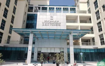 a building with a sign that reads denver nurses at Botanic Apartment 1BR, Pool, Tennis Court in Dubai