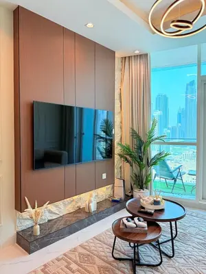 a living room with a large tv on a wall at Downtown Escape 2BR with Full BurjKhalifa Panorama in Dubai