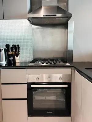 a kitchen with a stove top oven in a kitchen at Downtown Escape 2BR with Full BurjKhalifa Panorama in Dubai