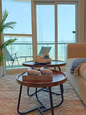 a living room with two tables and a couch at Downtown Escape 2BR with Full BurjKhalifa Panorama in Dubai