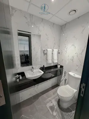 a bathroom with a toilet and a sink at Downtown Living - Business Bay 1BR in Dubai