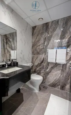 a bathroom with a sink and a toilet and a mirror at Downtown Living - Business Bay 1BR in Dubai