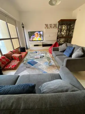 a living room with two couches and a flat screen tv at Alsahel Vacation 1 in Dubai