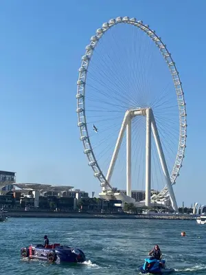 a ferris wheel and a race car in the water at Alsahel Vacation 1 in Dubai
