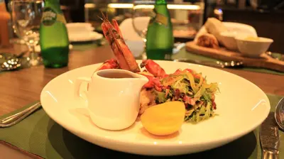 a plate of food on a table with a cup of coffee at Treppan Hotel & Suites By Fakhruddin in Dubai