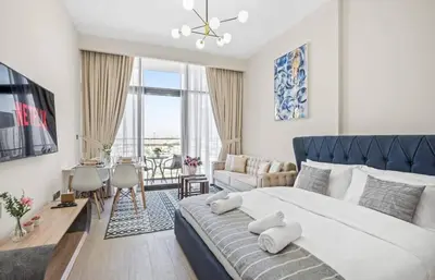 a bedroom with a large bed and a living room at Azizi Riviera , Meydan, Dubai Burj Khalifa view in Dubai