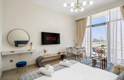 a bedroom with two beds and a living room at Azizi Riviera , Meydan, Dubai Burj Khalifa view in Dubai