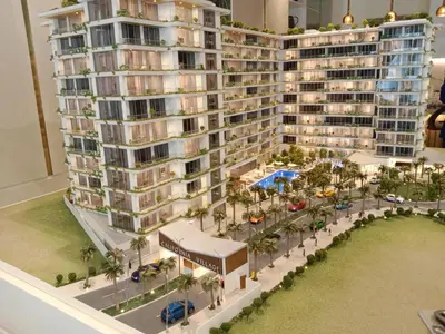 an aerial view of a building with a resort at California Village Dubai in Dubai