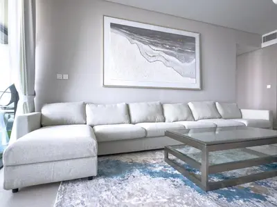 a living room with a white couch and a coffee table at ADDRESS BEACH RESORT Residence Million Dollar View 39th floor DXB AIRPORT VIP Shuttle option in Dubai