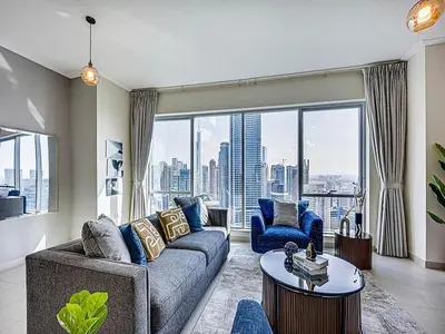 a living room with a couch and chairs and a large window at Bright 3BR with Maid, Sofa Bed, Marina Views - 32AB02 in Dubai