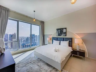 a bedroom with a large bed and a large window at Bright 3BR with Maid, Sofa Bed, Marina Views - 32AB02 in Dubai