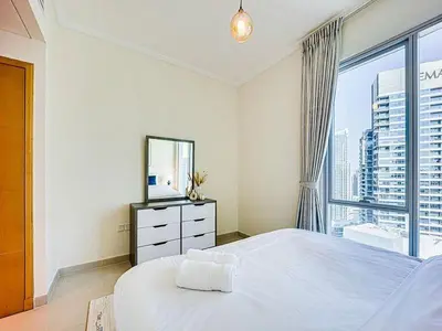 a bedroom with a large bed and a large window at Bright 3BR with Maid, Sofa Bed, Marina Views - 32AB02 in Dubai