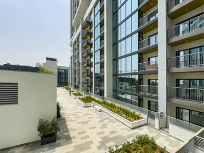an image of an apartment building with a courtyard at Luxury 1BR, The Crest, Sobha Hartland in Dubai