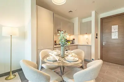 a dining room with a table and chairs at Luxury 1BR, The Crest, Sobha Hartland in Dubai