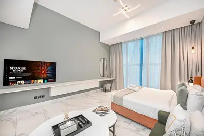 a hotel room with a bed and a flat screen tv at Modern Comfort with Pool and Free Parking Near Dubai Fountain and Burj Khalifa in Dubai