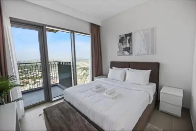 a bedroom with a large bed with a large window at Experience the Downtown Views Perfect 2BR wt Balco in Dubai