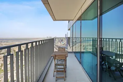 a balcony with a wooden table and chairs on it at Experience the Downtown Views Perfect 2BR wt Balco in Dubai