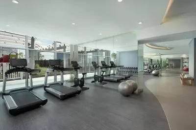 a gym with treadmills and exercise equipment in a building at Experience the Downtown Views Perfect 2BR wt Balco in Dubai