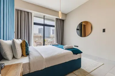 a bedroom with a large bed and a large window at Oxford Boulevard - 1 BR Apartment - Allsopp & Allsopp in Dubai