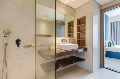 a bathroom with a sink and a shower at Oxford Boulevard - 1 BR Apartment - Allsopp & Allsopp in Dubai