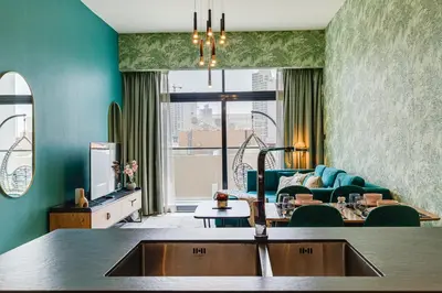 a living room with a couch and a table at Oxford Boulevard - 1 BR Apartment - Allsopp & Allsopp in Dubai