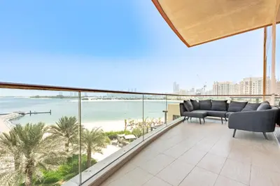 a living room with a view of the beach at Stunning Sea View 3BR with Private Beach in Dubai