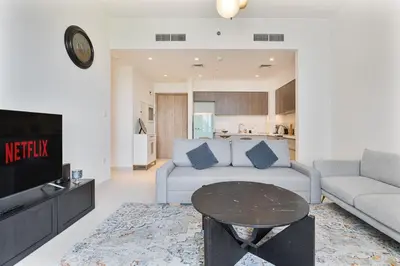 a living room with a couch and a table at Bright 1BR APT in Dubai Hills Near Burj Khalifa in Dubai