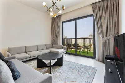 a living room with a couch and a table at Bright 1BR APT in Dubai Hills Near Burj Khalifa in Dubai