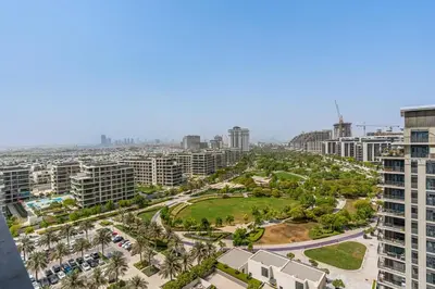 an aerial view of a city with palm trees and buildings at Bright 1BR APT in Dubai Hills Near Burj Khalifa in Dubai