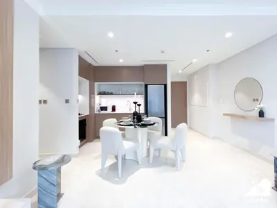 a dining room with a table and white chairs at Elegant 1B by the Beach & iconic Views in Dubai