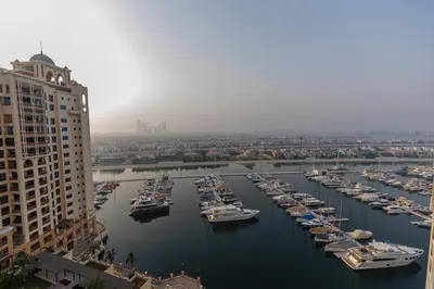 a group of boats are docked in a harbor at Panoramic Palm Jumeirah view 1 BedRoom Apartment- Holistay Luxury Collection in Dubai