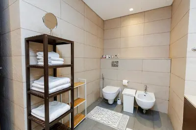 a bathroom with a toilet and a sink at Panoramic Palm Jumeirah view 1 BedRoom Apartment- Holistay Luxury Collection in Dubai