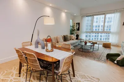 a living room with a table and a couch at Panoramic Palm Jumeirah view 1 BedRoom Apartment- Holistay Luxury Collection in Dubai