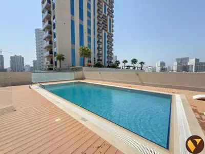a swimming pool on the roof of a building at Vogue JVC Jeewar Tower near Circle Mall, One Bedroom Apartment with Balcony and City View, Access to all Amenities in Dubai
