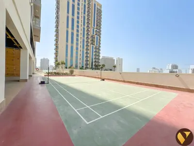 a tennis court on the roof of a building at Vogue JVC Jeewar Tower near Circle Mall, One Bedroom Apartment with Balcony and City View, Access to all Amenities in Dubai