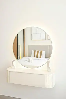 a mirror on a shelf with a bed in a room at Golden Stays - Private Pool in Binghatti Tulip I Prime JVC 2BR I Balcony Access in Dubai