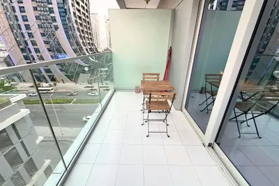 a balcony with a table and chairs on a building at Stunning Burj Views Studio Mins to Dubai Mall 603 in Dubai