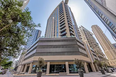 a large building in a city with tall buildings at Elegant 1BR near from Dubai Mall & Burj Khalifa in Dubai