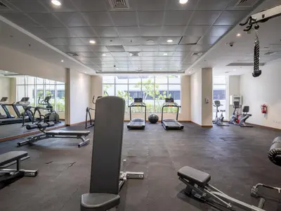 a gym with several treadmills and cardio machines at Elegant 1BR near from Dubai Mall & Burj Khalifa in Dubai