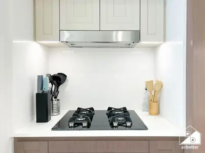 a kitchen with a stove and a microwave at Seaside 1BR Retreat , Beach & Atlantis Views in Dubai