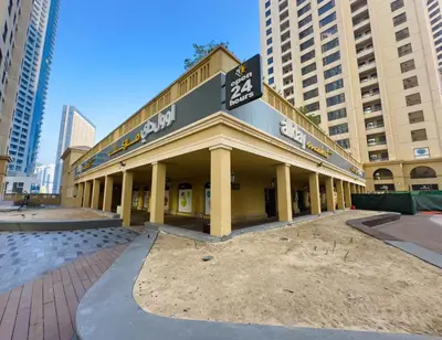 a building under construction in a city with tall buildings at Modern 1BR in JBR, Walk to Beach & Marina in Dubai