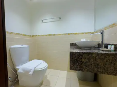a bathroom with a white toilet and a sink at Modern 1BR in JBR, Walk to Beach & Marina in Dubai