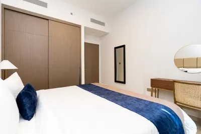 a bedroom with a large bed and a desk at CitiHome Elegant Finishing Prime Location in Dubai