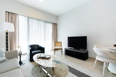 a living room with a couch and a tv at CitiHome Elegant Finishing Prime Location in Dubai