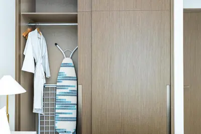 a closet with a tie hanging on a door at CitiHome Elegant Finishing Prime Location in Dubai